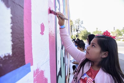 Student Painting a Mural